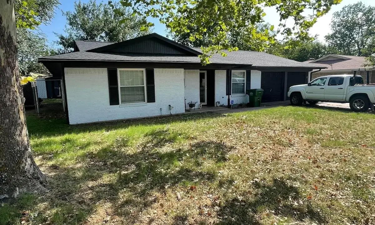 Professional roofing crew working on a residential roof in Newport